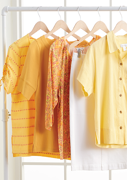 A rack of Christopher & Banks beautiful yellow tops, both solids and prints in long and short sleeve lengths, available today.