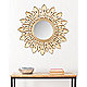 Gold-tone mirror on walll
