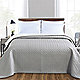 Grey coverlet on bed