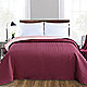 Rose coverlet on bed